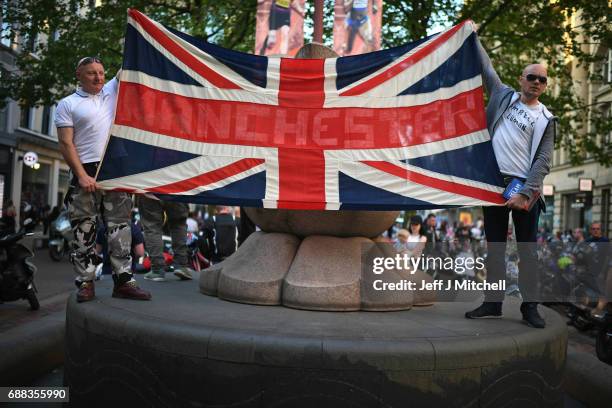 Scooter enthusiasts hold up a Union Jack flag as they arrive at St Ann's square to pay tribute to Olivia Campbell, who died in Monday's terror attack...