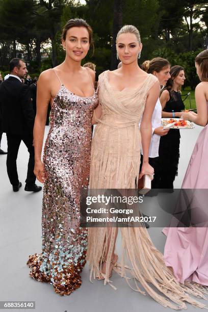 Irina Shayk and Kate Upton arrive at the amfAR Gala Cannes 2017 at Hotel du Cap-Eden-Roc on May 25, 2017 in Cap d'Antibes, France.