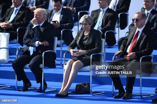 President Donald Trump, Britain's Prime Minister Theresa May and Turkish President Recep Tayyip Erdogan look on during the NATO summit ceremony at...