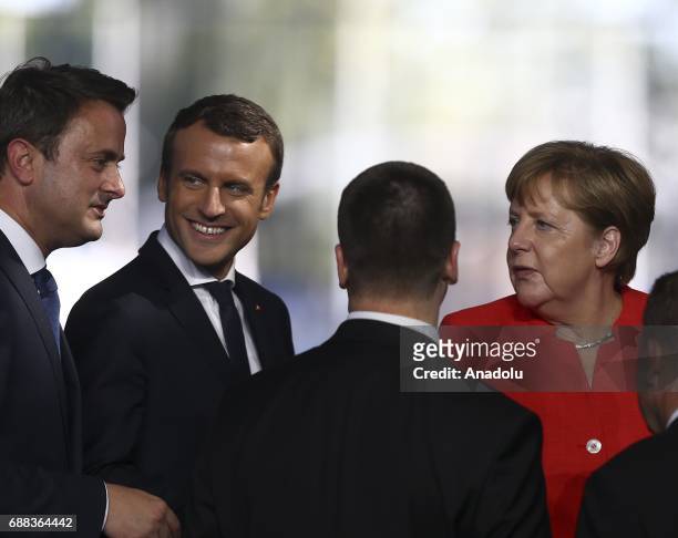 French President Emmanuel Macron speaks with Luxembourg's Prime Minister Xavier Bettel , German Chancellor Angela Merkel and other officials during...