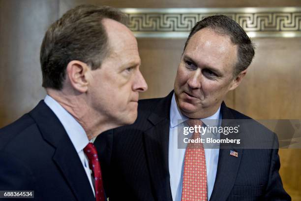 Robert Powelson, nominee to be a member of the Federal Energy Regulatory Commission for U.S. President Donald Trump, right, talks to Senator Patrick...