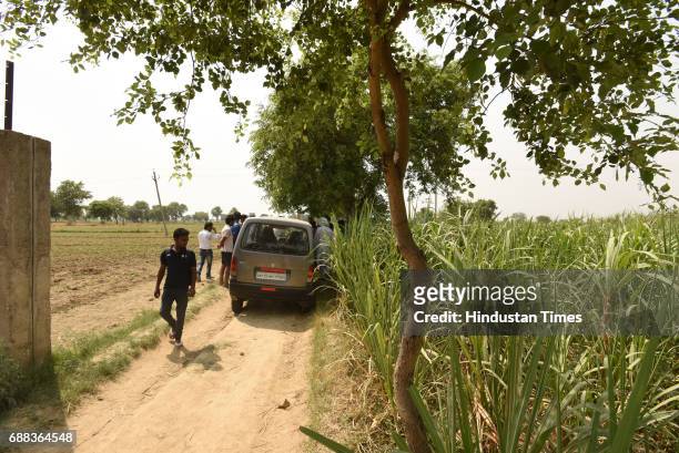 The car, in which the family was travelling, at the spot on the Jewar-Bulandshahr road off the Yamuna Expressway on May 25, 2017 in Greater Noida,...