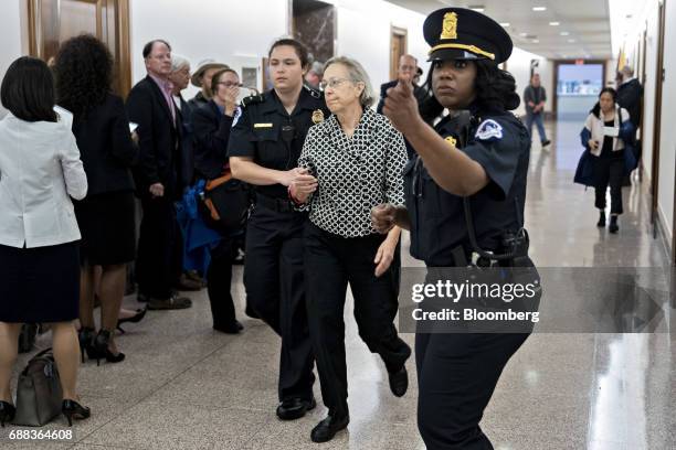 Demonstrator is led away by U.S. Capitol police after interrupting a Senate Energy and Natural Resources nomination hearing in Washington, D.C.,...