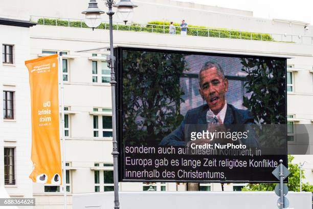 Monitor shows Former US President Barack Obama as he discusses with German Chancellor Angela Merkel during a panel discussion about democracy at the...