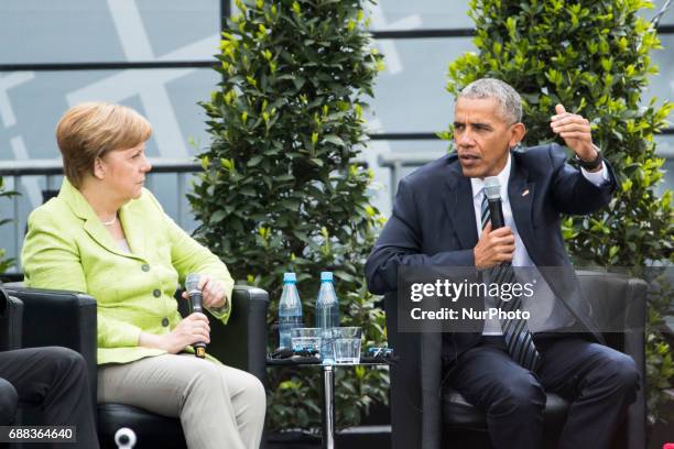 Former US President Barack Obama and German Chancellor Angela Merkel attend a panel discussion about democracy at the Protestant Kirchentag in...