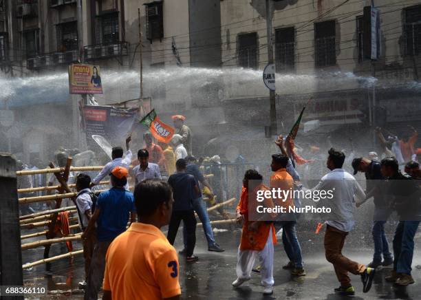 Indian police fire water cannons to disperse the Bharatiya Janata Party activists during their march to the police headquarters in Kolkata, India on...