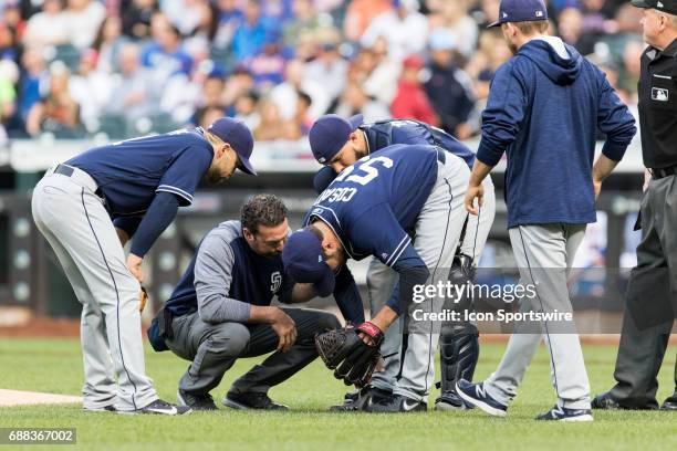 The Padres trainer checks out San Diego Padres Pitcher Jarred Cosart after getting hit by a ball during a regular season National League game between...