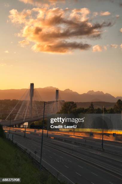 port mann bridge at sunset, bc, canada - surrey british columbia stock pictures, royalty-free photos & images
