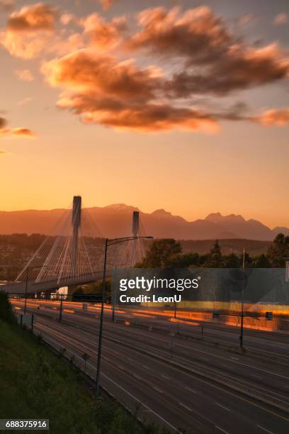 port mann bridge at sunset, bc, canada - new westminster stock pictures, royalty-free photos & images