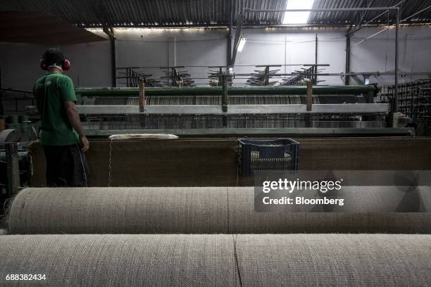 Worker cuts a carpet made from sisal fiber yarn at the Association for Sustainable and Solidarity Development of the Sisal Region facility in the...
