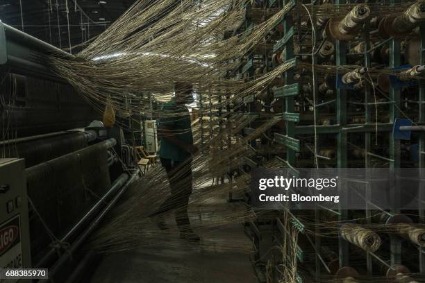 Worker monitors processed sisal fibers being weaved into spools at the Association for the Sustainable and Solidarity Development of the Sisal Region...