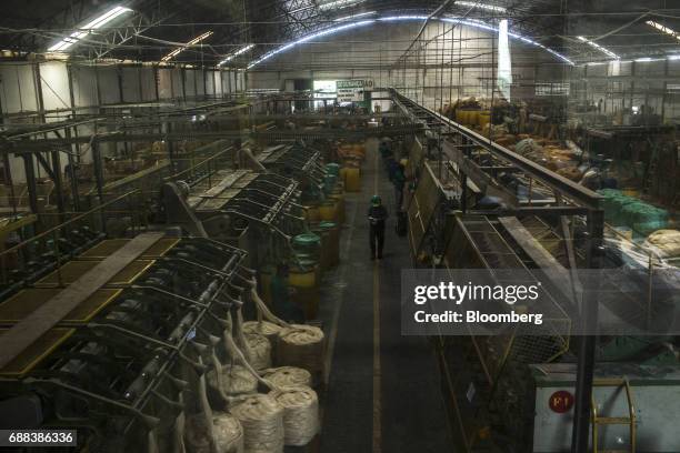 Machines process sisal fibers into spools of thread at the Association for the Sustainable and Solidarity Development of the Sisal Region facility in...