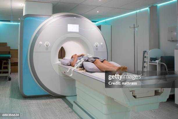 female patient lying for an mri scan - ct scan stock pictures, royalty-free photos & images