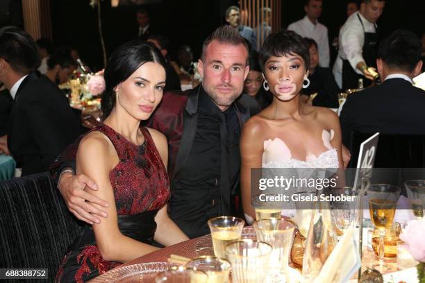 Andreea Sasu, Philipp Plein and Winnie Harlow attend the amfAR Gala Cannes 2017 at Hotel du Cap-Eden-Roc on May 25, 2017 in Cap d'Antibes, France.