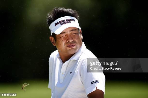 Yuta Ikeda of Japan reacts to a gust of wind on the 11th hole during Round One of the DEAN & DELUCA Invitational at Colonial Country Club on May 25,...