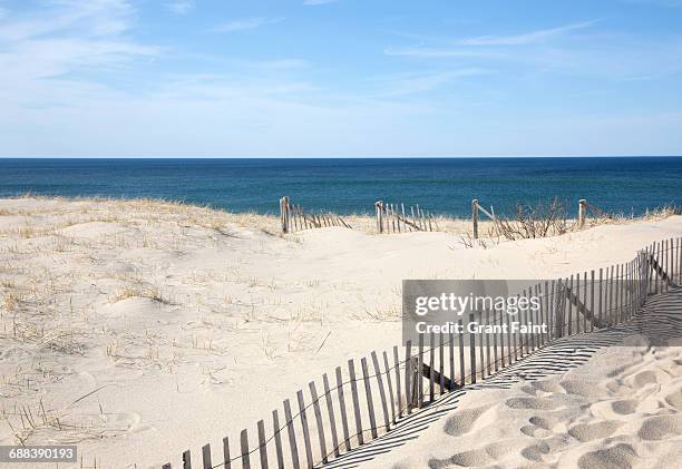 beach - beach fence stock-fotos und bilder