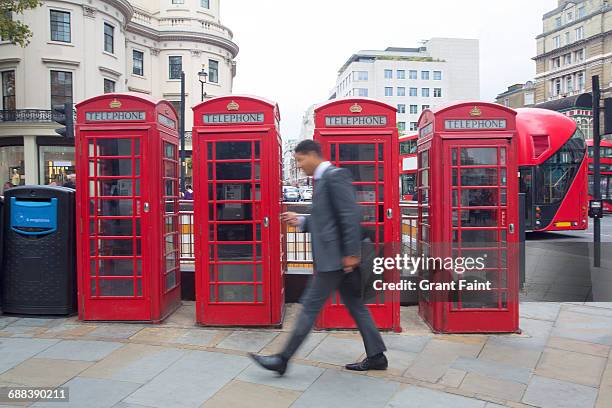 man walking. - public booth stock pictures, royalty-free photos & images