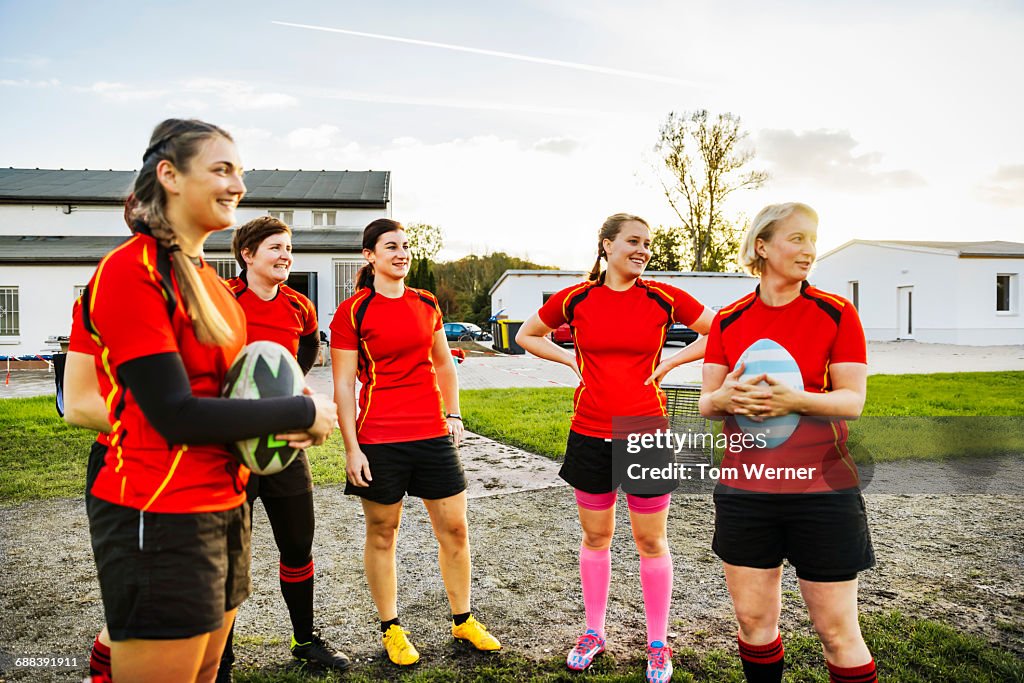 Female rugby team standing together and talking