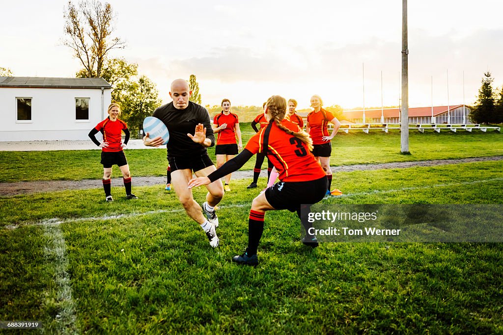 Female rugby tackling training
