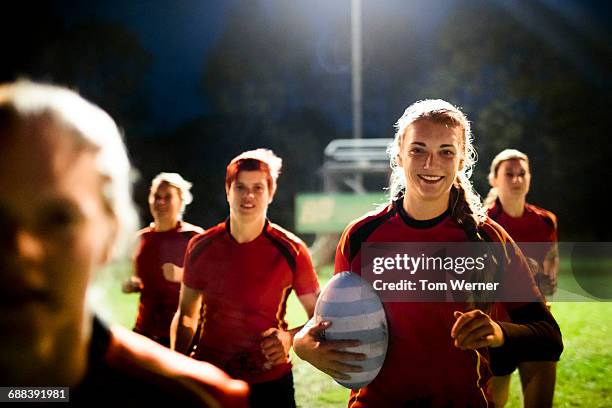 female rugby team running together - grittywomantrend stock pictures, royalty-free photos & images