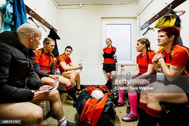 rugby team having a break in the locker room - grittywomantrend stock-fotos und bilder