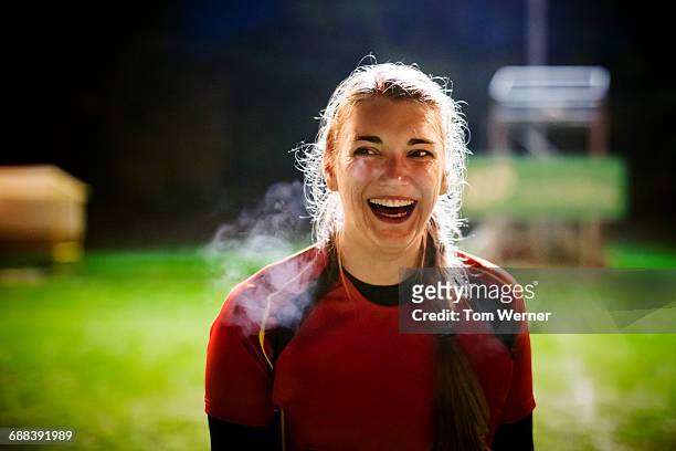female athlete portrait at night - rugby sport stock-fotos und bilder