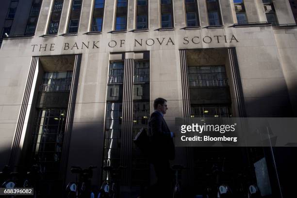 Pedestrian passes in front of the Bank of Nova Scotia building in Toronto, Ontario, Canada, on Friday, May 19, 2017. Ontario is easing rules for its...