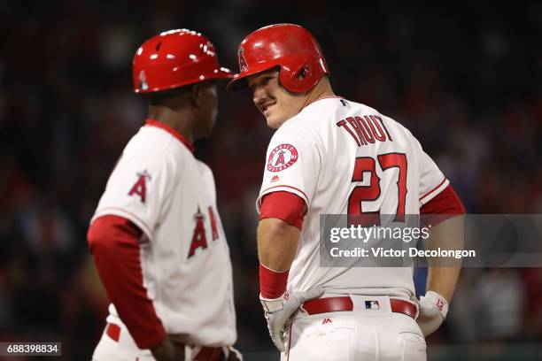 Mike Trout of the Los Angeles Angels of Anaheim looks back to first base coach Alfredo Griffin at first base after hitting an rbi single to shallow...