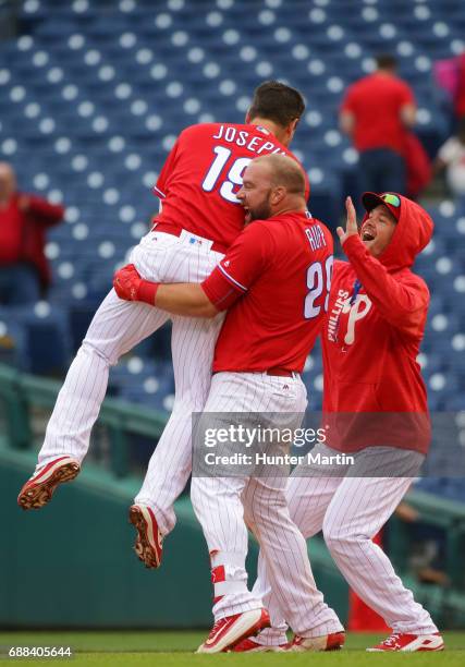 Tommy Joseph of the Philadelphia Phillies is picked up by Cameron Rupp after hitting a game winning walk-off RBI single in the 11th inning during a...