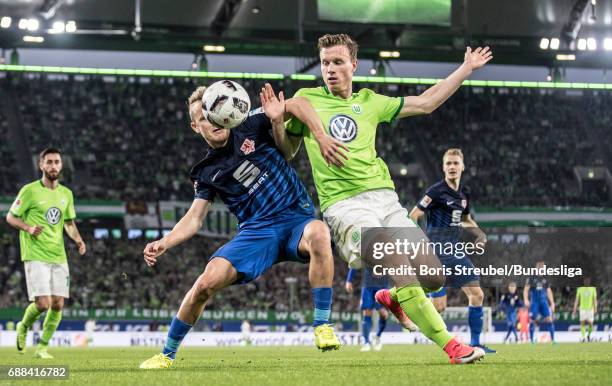 Nik Omladic of Eintracht Brauschweig battles for the ball with Yannick Gerhardt of VfL Wolfsburg during the Bundesliga Playoff Leg 1 match between...