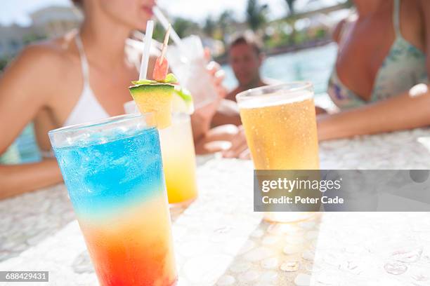 friends relaxing in pool with cocktails - all inclusive holiday stock-fotos und bilder