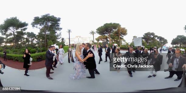 David Beckham greets Karolina Kurkova as they attend the amfAR Gala Cannes 2017 at Hotel du Cap-Eden-Roc on May 25, 2017 in Cap d'Antibes, France.