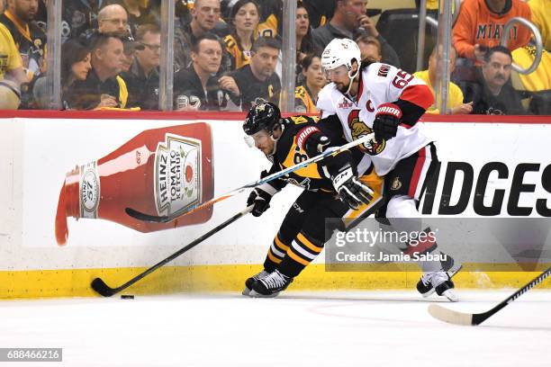 Sidney Crosby of the Pittsburgh Penguins collides with Erik Karlsson of the Ottawa Senators during the first period in Game Seven of the Eastern...