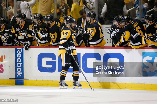 Chris Kunitz of the Pittsburgh Penguins celebrates with his teammates after scoring a goal against Craig Anderson of the Ottawa Senators during the...