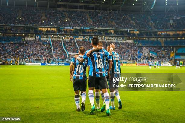 Lucas Barrios of Brazil's Gremio celebrates with teammates after scoring against Venezuela's Zamora during their Copa Libertadores football match at...