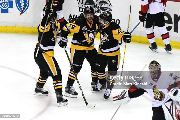 Chris Kunitz of the Pittsburgh Penguins celebrates with his teammates after scoring a goal against Craig Anderson of the Ottawa Senators during the...