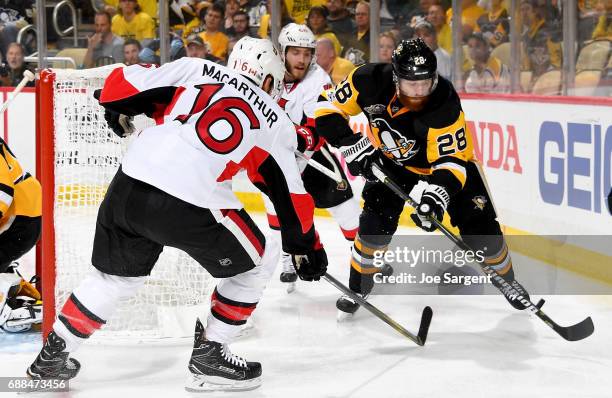 Ian Cole of the Pittsburgh Penguins handles the puck against Clarke MacArthur of the Ottawa Senators in Game Seven of the Eastern Conference Final...