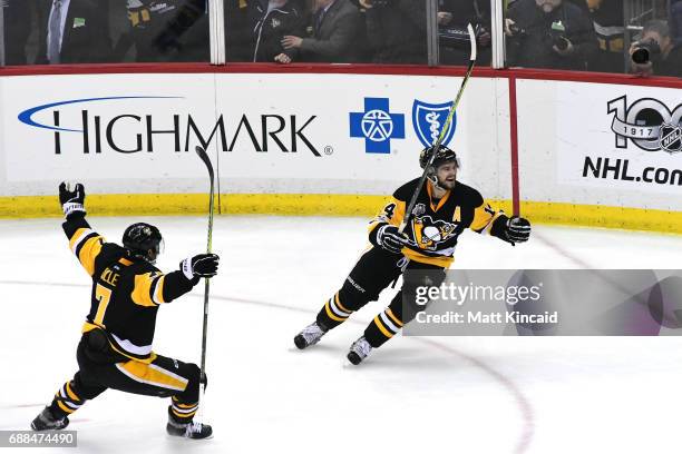 Chris Kunitz of the Pittsburgh Penguins celebrates with his teammates after scoring a goal against Craig Anderson of the Ottawa Senators during the...