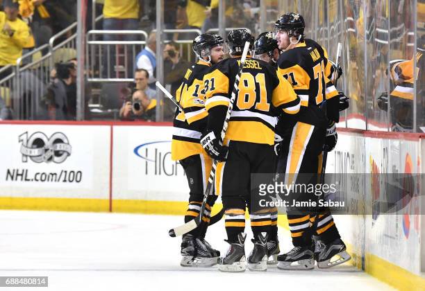 Justin Schultz of the Pittsburgh Penguins celebrates with his teammates after scoring a goal against Craig Anderson of the Ottawa Senators during the...