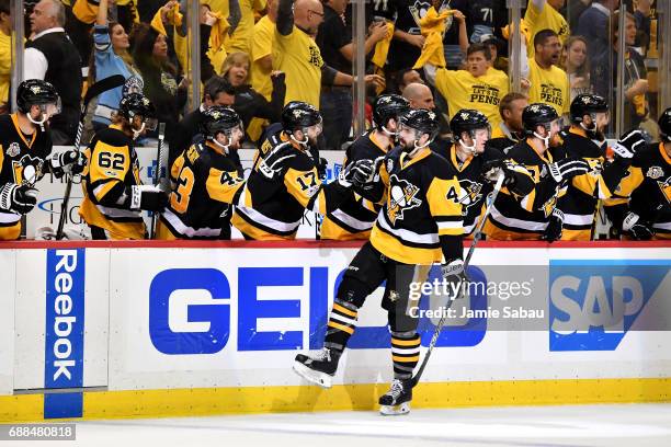 Justin Schultz of the Pittsburgh Penguins celebrates with his teammates after scoring a goal against Craig Anderson of the Ottawa Senators during the...