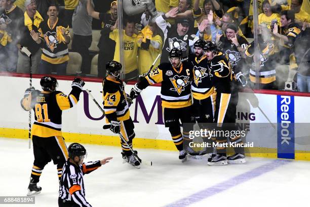 Justin Schultz of the Pittsburgh Penguins celebrates with his teammates after scoring a goal against Craig Anderson of the Ottawa Senators during the...