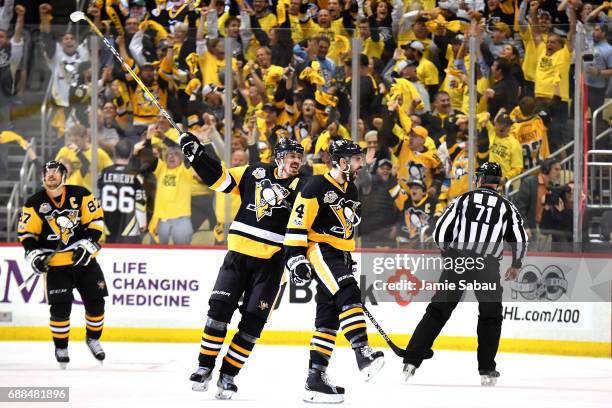 Justin Schultz of the Pittsburgh Penguins celebrates with his teammates after scoring a goal against Craig Anderson of the Ottawa Senators during the...