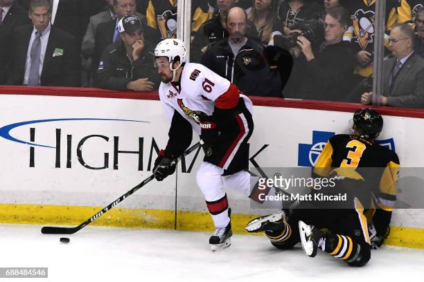 Mark Stone of the Ottawa Senators skates with the puck as Olli Maatta of the Pittsburgh Penguins hits the boards during the third period in Game...