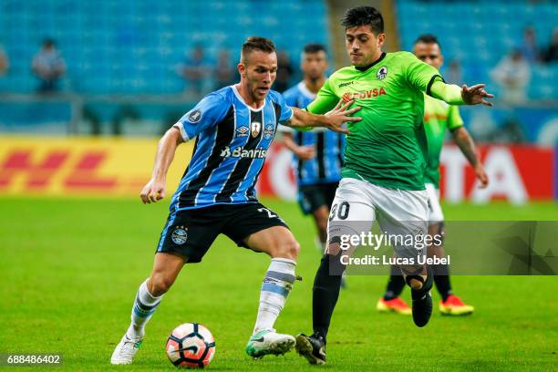 Arthur of Gremio battles for the ball against Ricardo Clarke of Zamora during the match Gremio v Zamora as part of Copa Bridgestone Libertadores...