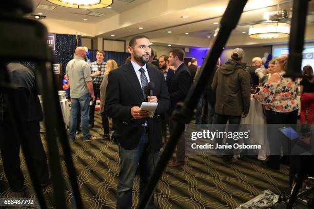 Reporter Ken McGrath, with KULR News out of Billings, Montana, gets ready to broadcast as guests at Republican Greg Gianforte election party wait to...