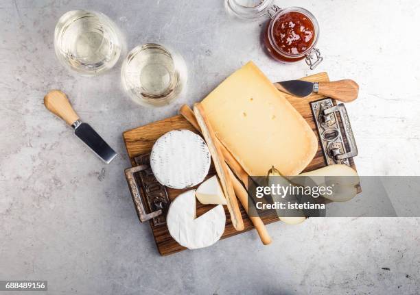 savory dessert. cheese platter served with dessert wine, jam and pear - cheese platter stock-fotos und bilder