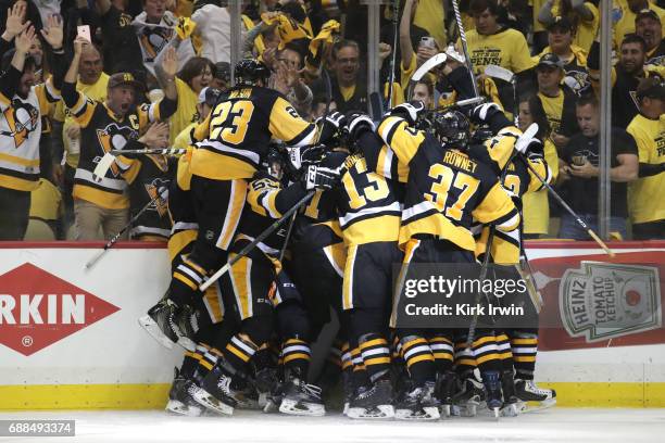 The Pittsburgh Penguins celebrate after Chris Kunitz scored the game winning goal against Craig Anderson of the Ottawa Senators in the second...