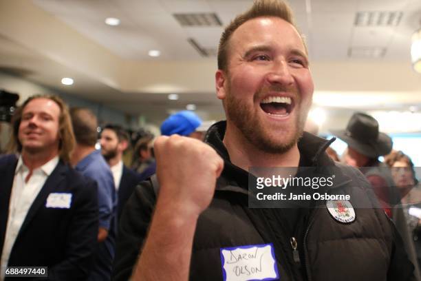 Daron Olson reacts as Republican Greg Giangorte's lead in Montana's special House Election in announced on TV as guests wait to hear the outcome in...