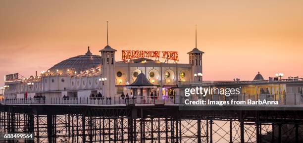 brighton pier as the winter sun starts to set, east sussex, uk - brighton races stock pictures, royalty-free photos & images