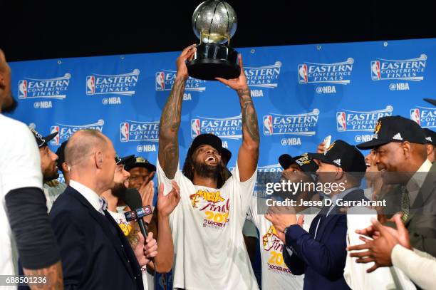 Derrick Williams of the Cleveland Cavaliers holds up the Eastern Conference Finals trophy after their victory against the Boston Celtics during Game...